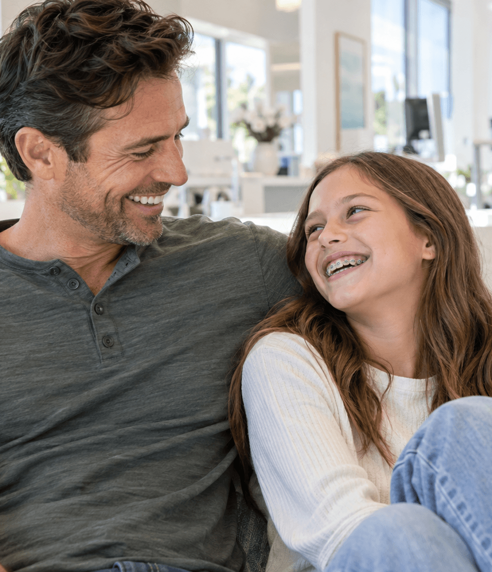 Parent and child smiling together during an orthodontic visit